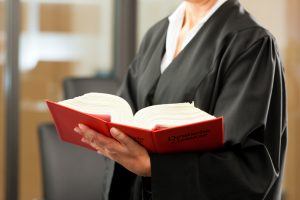 Female lawyer with German civil law code - only torso to be seen, close-up